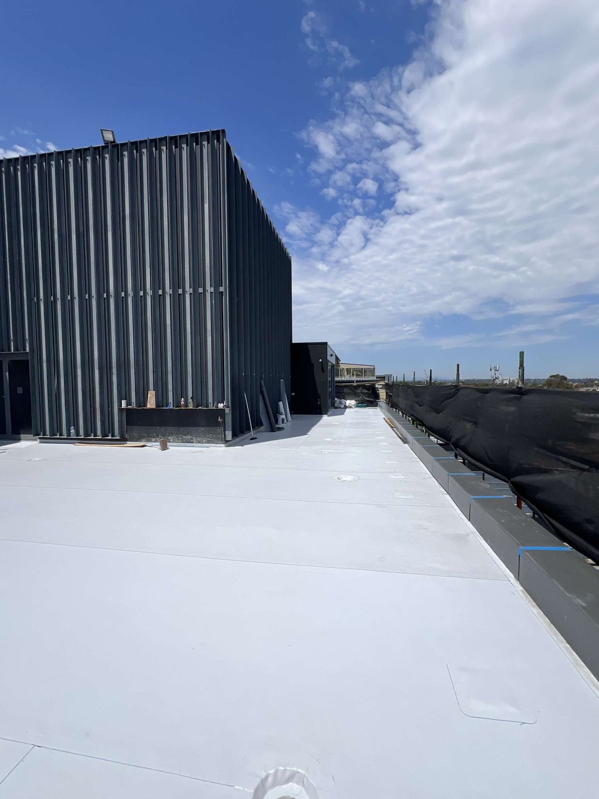 Sheet membrane rooftop beside a plant room